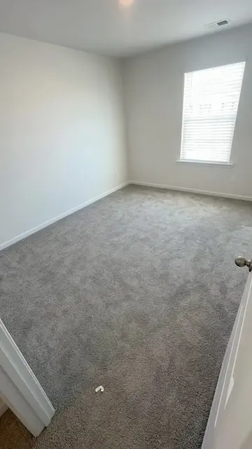 Dirty carpet with embedded soil and stains before professional cleaning in Charlotte NC