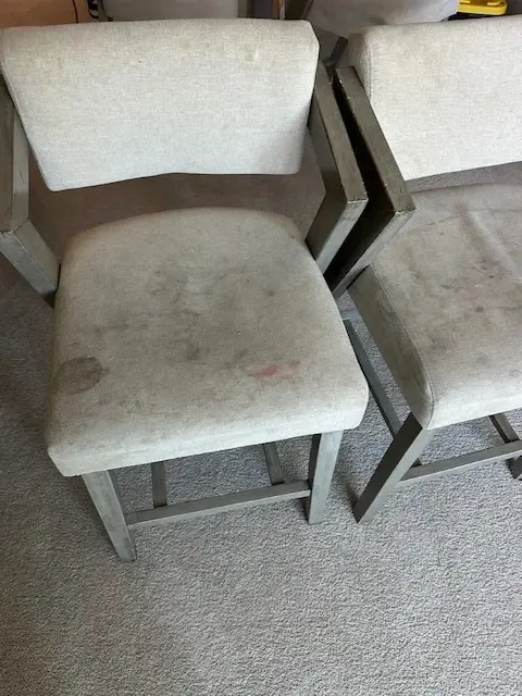 Stained dining chair upholstery before professional cleaning by Velvo in Fort Mill SC